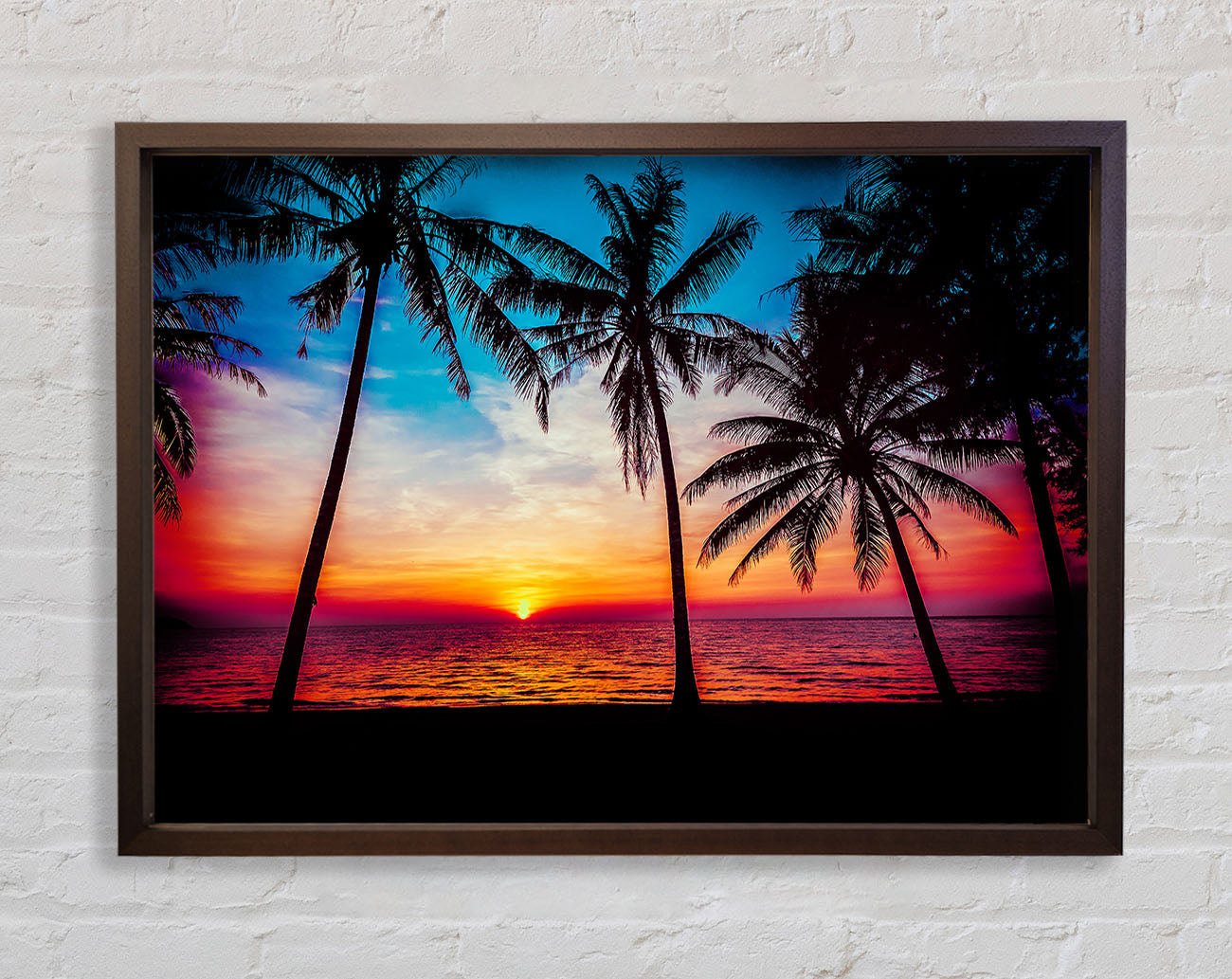 As The Sun Goes Down Between The Palm Trees Framed Wall Art