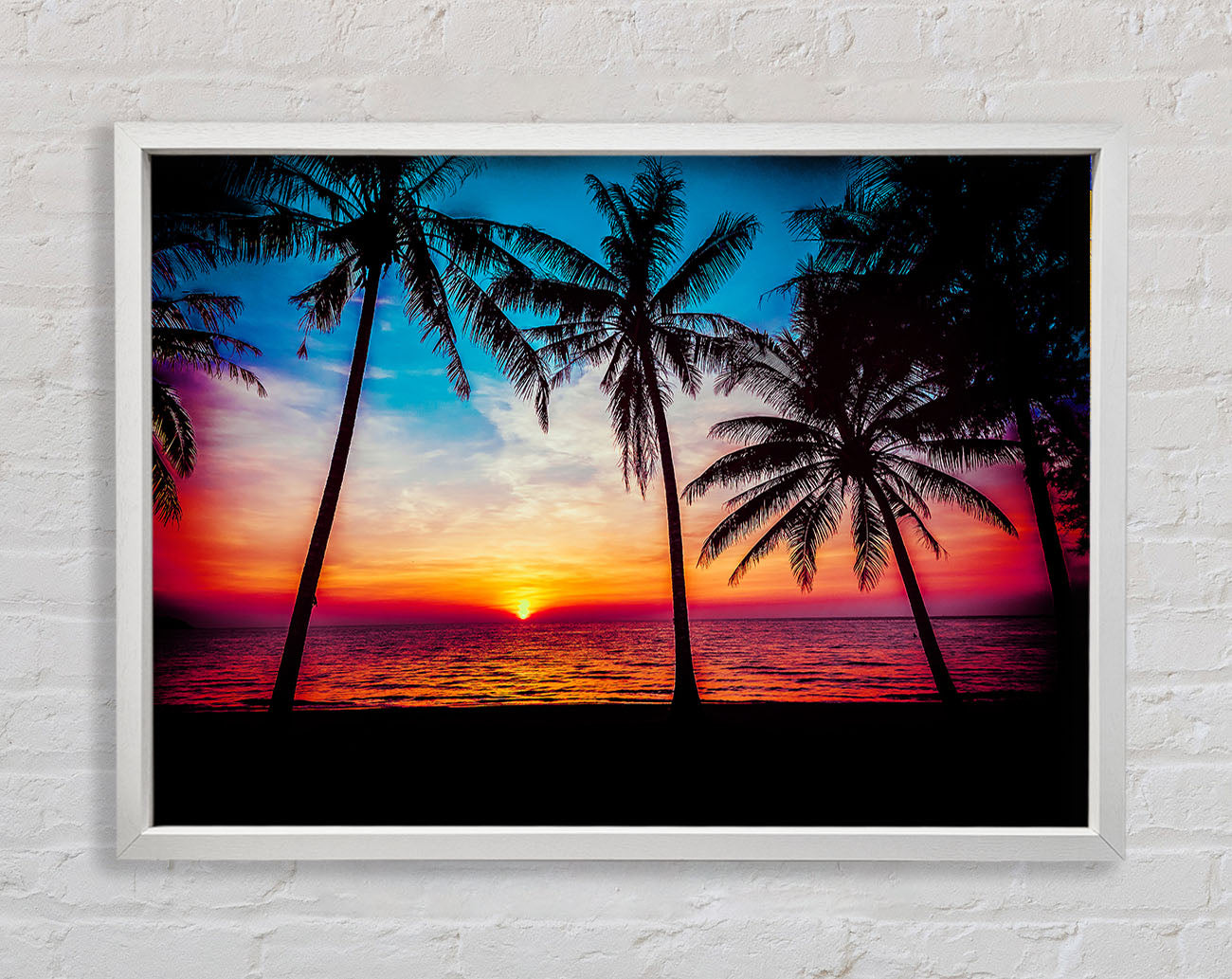 As The Sun Goes Down Between The Palm Trees Framed Wall Art