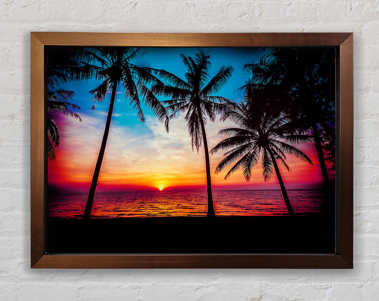 As The Sun Goes Down Between The Palm Trees Framed Wall Art