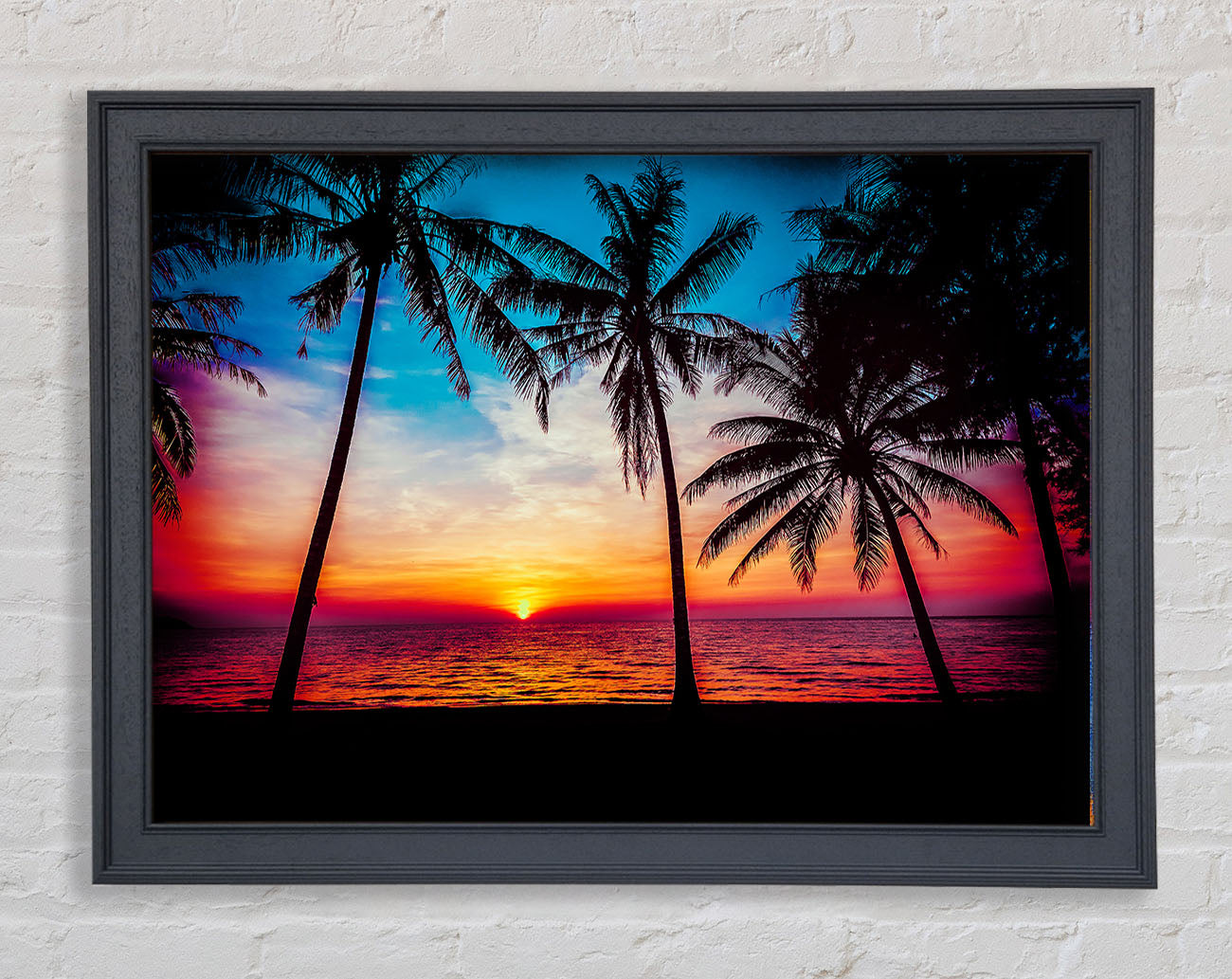 As The Sun Goes Down Between The Palm Trees Framed Wall Art