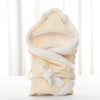 Newborn baby being hugged and swaddled by baby