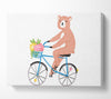 Bear Riding A Bike Canvas Wall Art